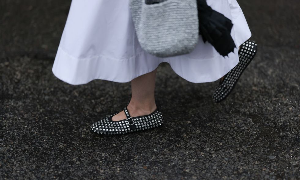 new york, new york september 08 guest, shoe detail, seen outside collina strada show wearing silver necklace, white maxi dress, silver handbag and silver studed alaia ballet flats on september 08, 2023 in new york city photo by jeremy moellergetty images
