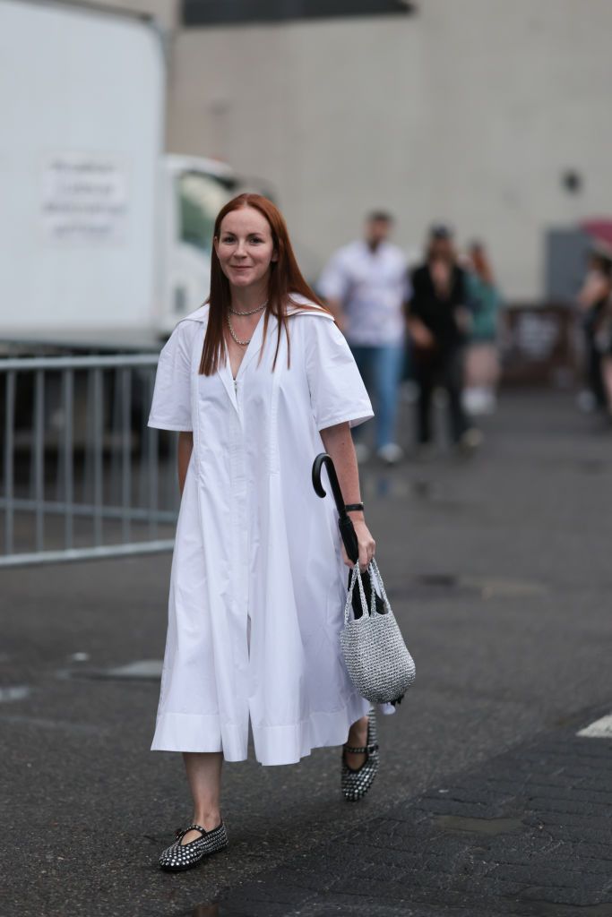 new york, new york september 08 guest seen outside collina strada show wearing silver necklace, white maxi dress, silver handbag and silver studed alaia ballet flats on september 08, 2023 in new york city photo by jeremy moellergetty images