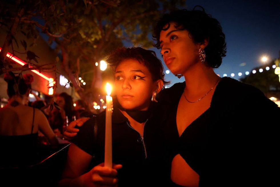 los angeles, ca   november 20 jacky santiago, 24, left, and khayra cq, mentado, 22, both of los angeles, attend a candlelight vigil along santa monica blvd in front of roccos on sunday, nov 20, 2022 in los angeles, ca city leaders and community organizations hold a candlelight vigil in solidarity with the lgbtq community of colorado springs, colorado, where at least five people were shot to death at a nightclub late saturday gary coronado  los angeles times via getty images