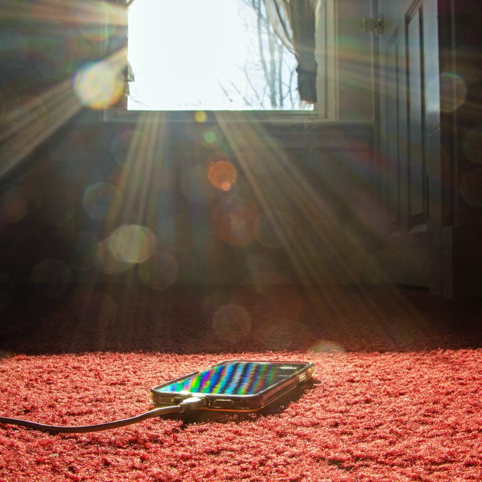 Smartphone charging on ground near window info detox