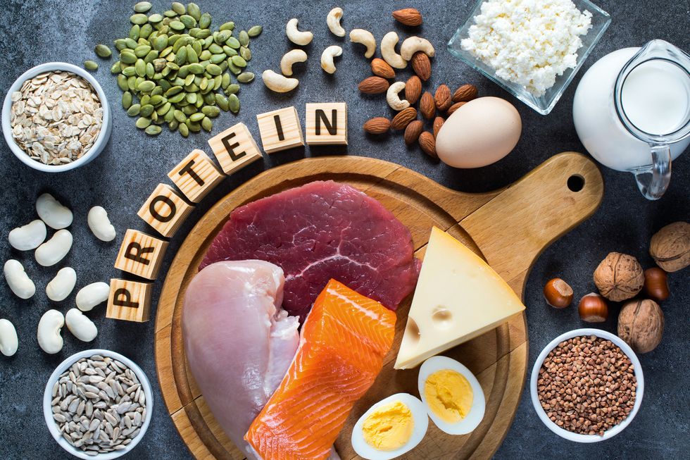 high protein food as meat, fish, dairy, eggs, buckwheat, oatmeal, nuts, bean, pumpkin seed and sunflower seed top view