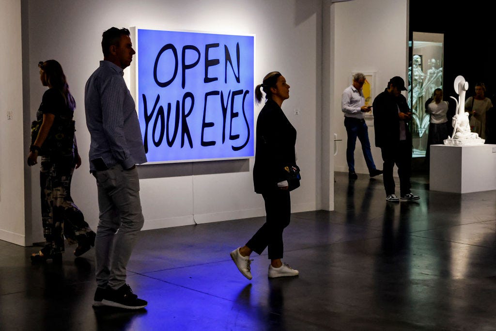 people look at artwork during the miami art basel 2022 at the convention center in miami beach, florida, december 2, 2022   restricted to editorial use   mandatory mention of the artist upon publication   to illustrate the event as specified in the caption photo by eva marie uzcategui  afp  restricted to editorial use   mandatory mention of the artist upon publication   to illustrate the event as specified in the caption  restricted to editorial use   mandatory mention of the artist upon publication   to illustrate the event as specified in the caption photo by eva marie uzcateguiafp via getty images