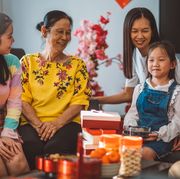lunar new year wishes family sitting around in living room celebrating chinese new year