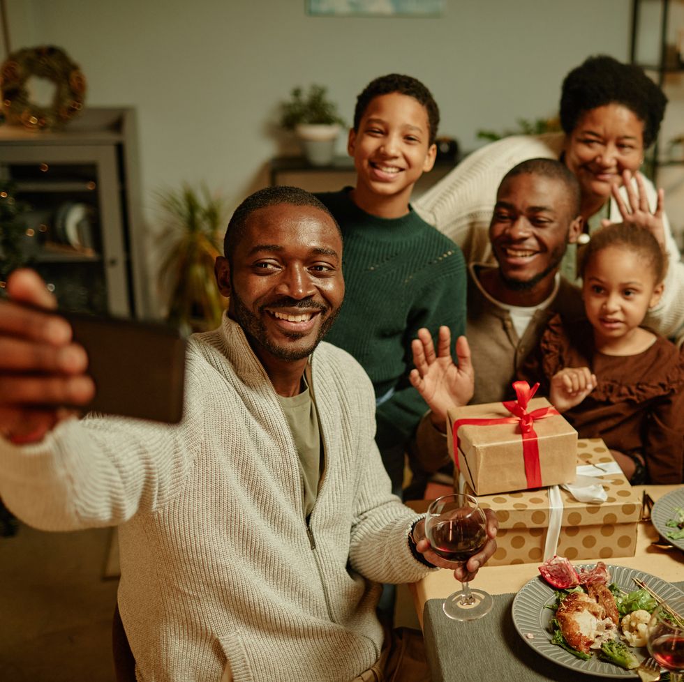 high angle portrait of happy african american family taking selfie photo while enjoying christmas at home together