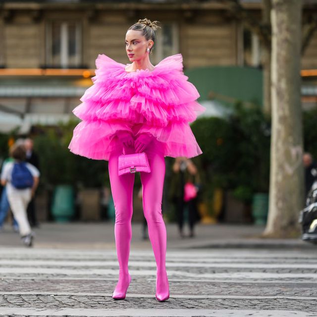 paris, france september 30 sira pevida wears silver large earrings, a neon pink ruffled oversized tulle top, neon pink nylon pointed heels pants shoes, a neon pink shiny leather crocodile print pattern hourglass handbag from balenciaga, neon pink gloves , outside giambattista valli, during paris fashion week womenswear springsummer 2023, on september 30, 2022 in paris, france photo by edward berthelotgetty images