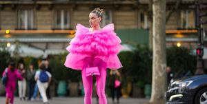 paris, france september 30 sira pevida wears silver large earrings, a neon pink ruffled oversized tulle top, neon pink nylon pointed heels pants shoes, a neon pink shiny leather crocodile print pattern hourglass handbag from balenciaga, neon pink gloves , outside giambattista valli, during paris fashion week womenswear springsummer 2023, on september 30, 2022 in paris, france photo by edward berthelotgetty images