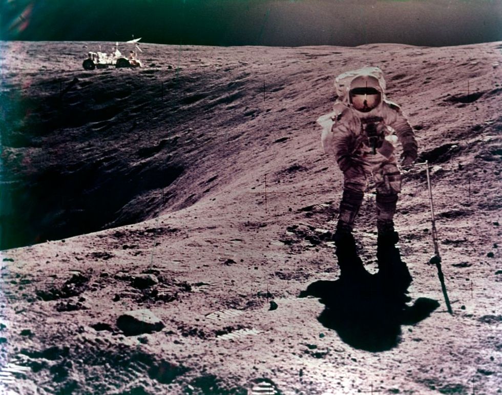 astronaut charles duke at the descartes landing site, apollo 16 mission, april 1972 charles duke collecting lunar samples on the surface of the moon, with the lunar roving vehicle, on the rim of plum crater, in the distance artist john watts young photo by heritage spaceheritage imagesgetty images