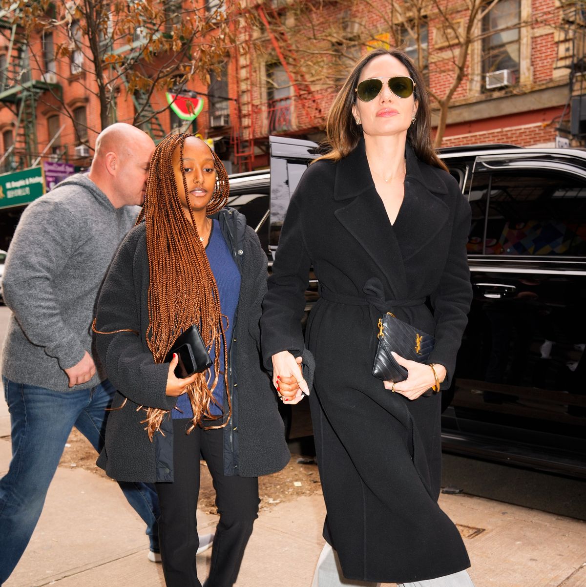 Angelina Jolie Wears Oversize Coat & Satin Scarf for Shopping Trip