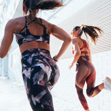 Rear view of two sporty young women running in the city This is an image