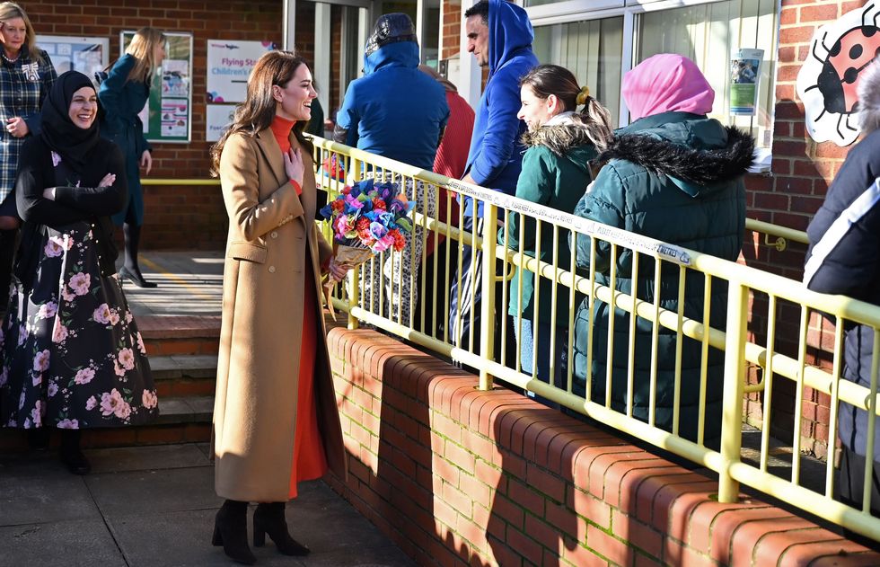 luton, england january 18 catherine, princess of wales talks with parents waiting to collect their children as she leaves after visiting the foxcubs nursery on january 18, 2023 in luton, england the princess of waless visit is part of her work highlighting the importance of early childhood development photo by justin tallis wpa poolgetty images