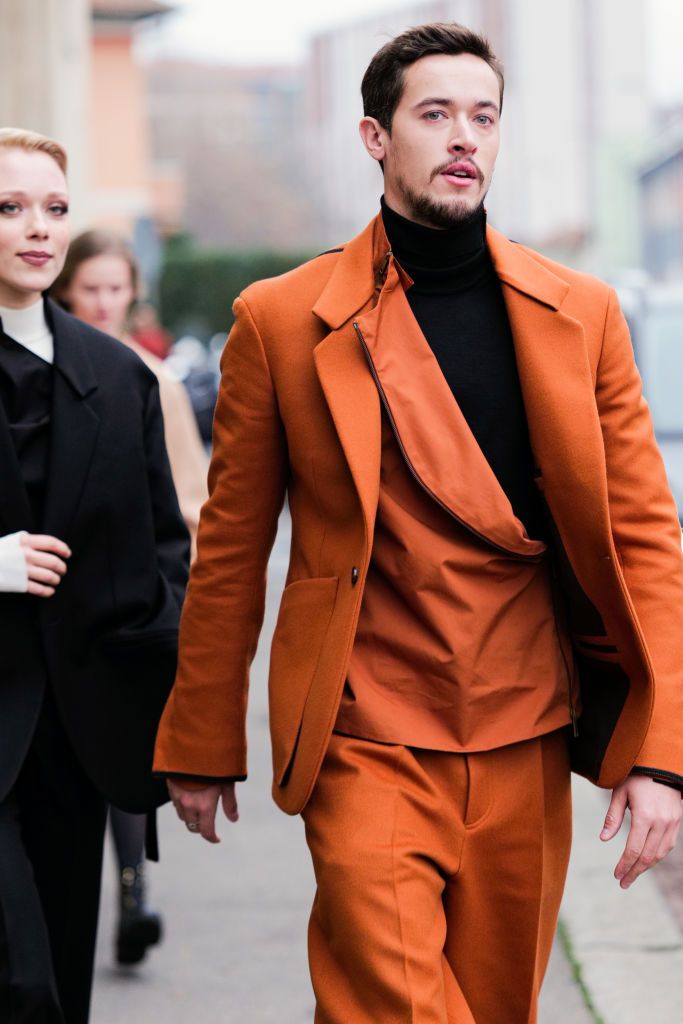 milan, italy january 16 a guest is seen wearing orange coat, asymetrical zipper jacket and pants outside the ermenegildo zegna show during the milan menswear fallwinter 20232024 on january 16, 2023 in milan, italy photo by claudio laveniagetty images
