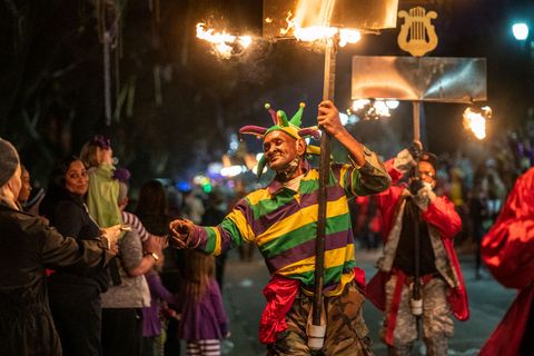 flambeaux light the way for the 2022 krewe of orpheus parade that takes place on the traditional uptown parade route