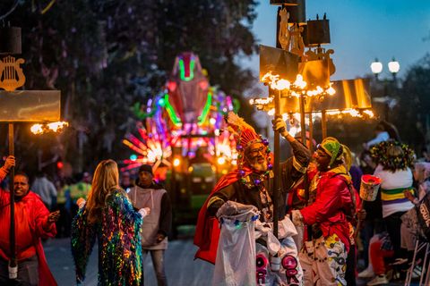 flambeaux light the way for the 2022 krewe of orpheus parade