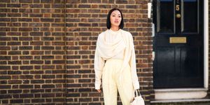 london, england september 14 tiffany hsu wears a scarf, a white flowing top, pale yellow cropped pants, white heels shoes, a leather crocodile pattern bag, during london fashion week september 2019 on september 14, 2019 in london, england photo by edward berthelotgetty images