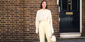 london, england september 14 tiffany hsu wears a scarf, a white flowing top, pale yellow cropped pants, white heels shoes, a leather crocodile pattern bag, during london fashion week september 2019 on september 14, 2019 in london, england photo by edward berthelotgetty images