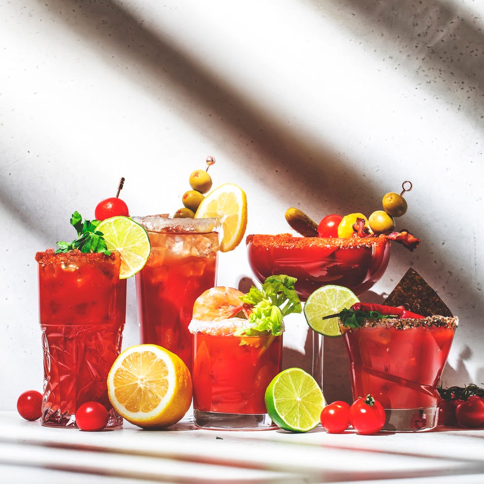 bloody mary, joseph, caesar and other cocktails variation with tomato juice, vodka, hot sauce and celery. cocktail party. gray background, hard light