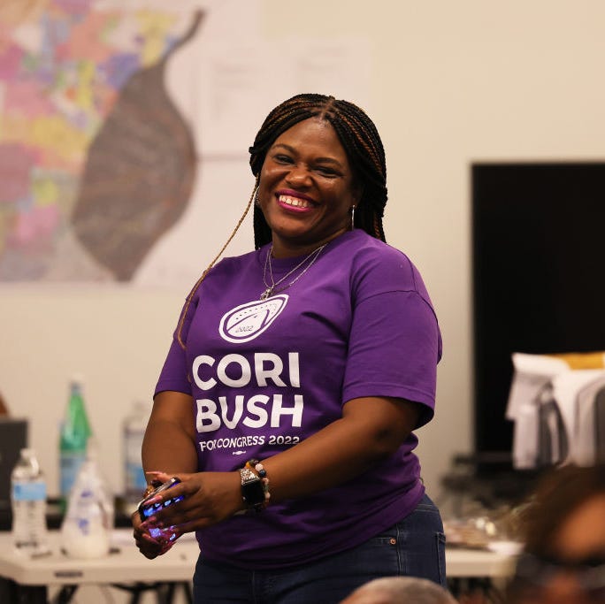 us rep cori bush d mo smiles as she listens to speakers at campaign headquarters