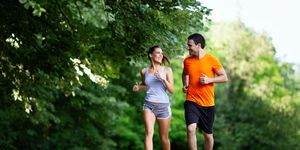 portrait of happy young fit people running together ourdoors couple sport healthy lifetsyle concept