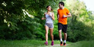 portrait of happy young fit people running together ourdoors couple sport healthy lifetsyle concept