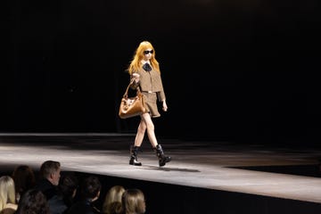 a model in a brown jacket and matching miniskirt walks the runway at the celine at the wiltern show in los angeles