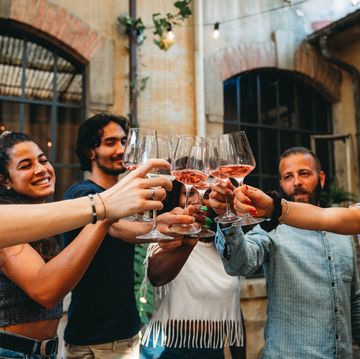 a group of people holding glasses of wine