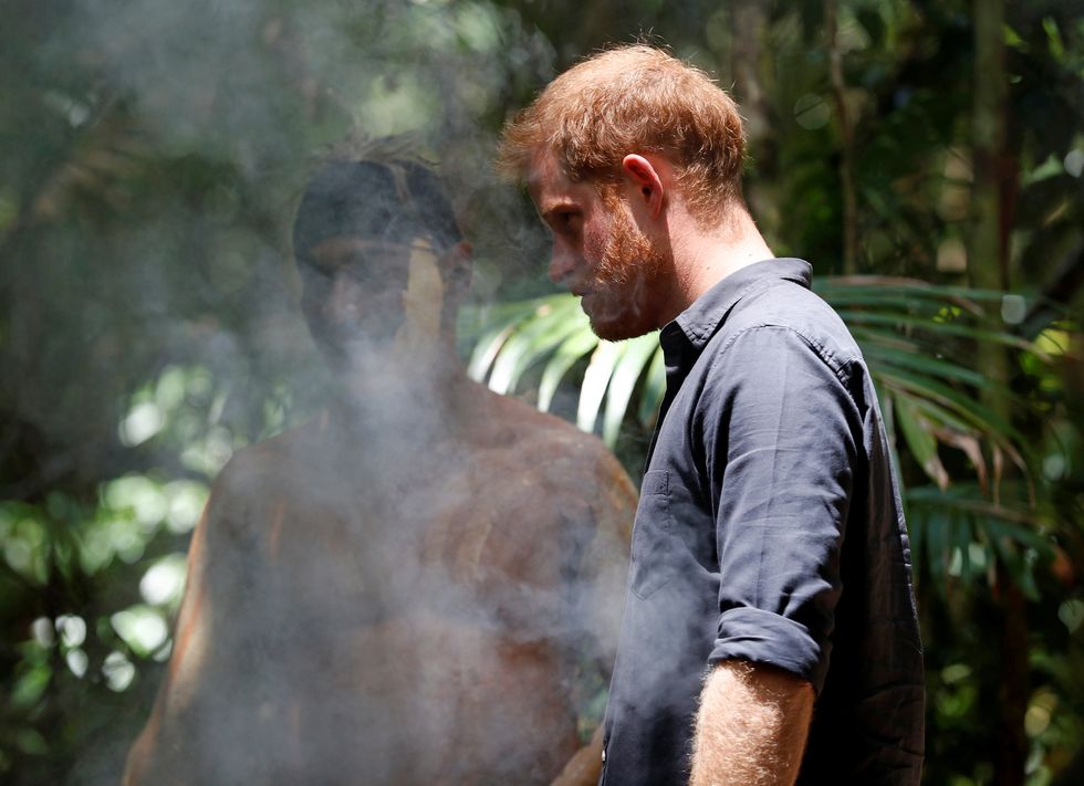 fraser island, australia october 22 prince harry, duke of sussex takes part in a smoking ceremony with a member of the butchulla people during a dedication ceremony of the forests of kgari the queens commonwealth canopy, on october 22, 2018 on fraser island, australia the duke and duchess of sussex are on their official 16 day autumn tour visiting cities in australia, fiji, tonga and new zealand photo by phil noble poolgetty images