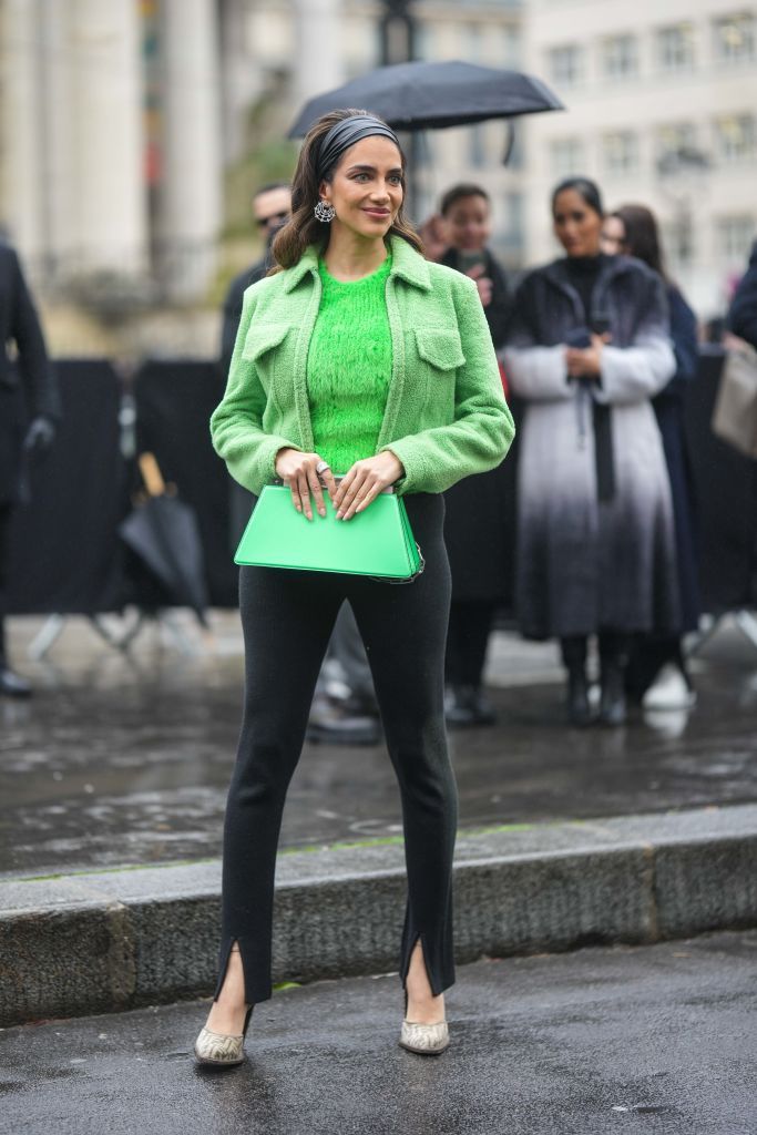 paris, france january 26 jessica kahawaty wears a black shiny leather large head band, silver and diamonds earrings, a neon green fluffy t shirt, a green sheep zipper jacket from fendi, a green shiny leather handbag from fendi, black legging slit split pants, beige and brown embossed ff monogram pattern pumps heels shoes from fendi , outside fendi, during paris fashion week haute couture spring summer on january 26, 2023 in paris, france photo by edward berthelotgetty images