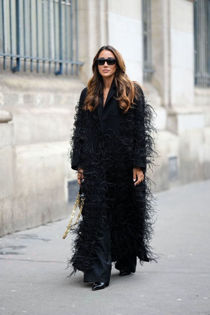 paris, france january 25 tamara kalinic wears black sunglasses, a black long blazer coat with embroidered feathers details from elie saab, diamonds and silver rings, a black shiny varnished leather handbag, black wide legs suit pants, black shiny leather pointed pumps heels shoes , outside elie saab, during paris fashion week haute couture spring summer, on january 25, 2023 in paris, france photo by edward berthelotgetty images