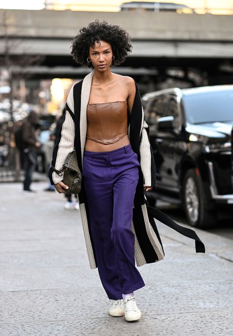 new york, new york february 10 a model is seen wearing a black and cream sweater, brown leather top and purple pants outside the rodarte show during new york fashion week fw 2023 on february 10, 2023 in new york city photo by daniel zuchnikgetty images