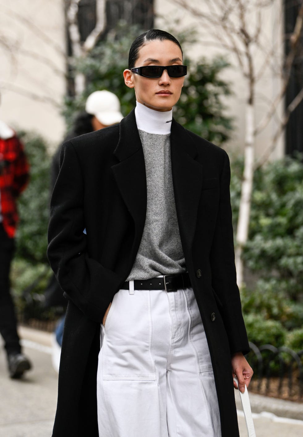 new york, new york february 12 model lina zhang is seen wearing a black coat, gray prada sweater, white pants and black sunglasses outside the jason wu show during new york fashion week fw 2023 on february 12, 2023 in new york city photo by daniel zuchnikgetty images