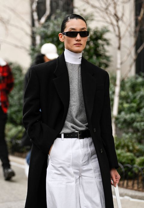 new york, new york february 12 model lina zhang is seen wearing a black coat, gray prada sweater, white pants and black sunglasses outside the jason wu show during new york fashion week fw 2023 on february 12, 2023 in new york city photo by daniel zuchnikgetty images