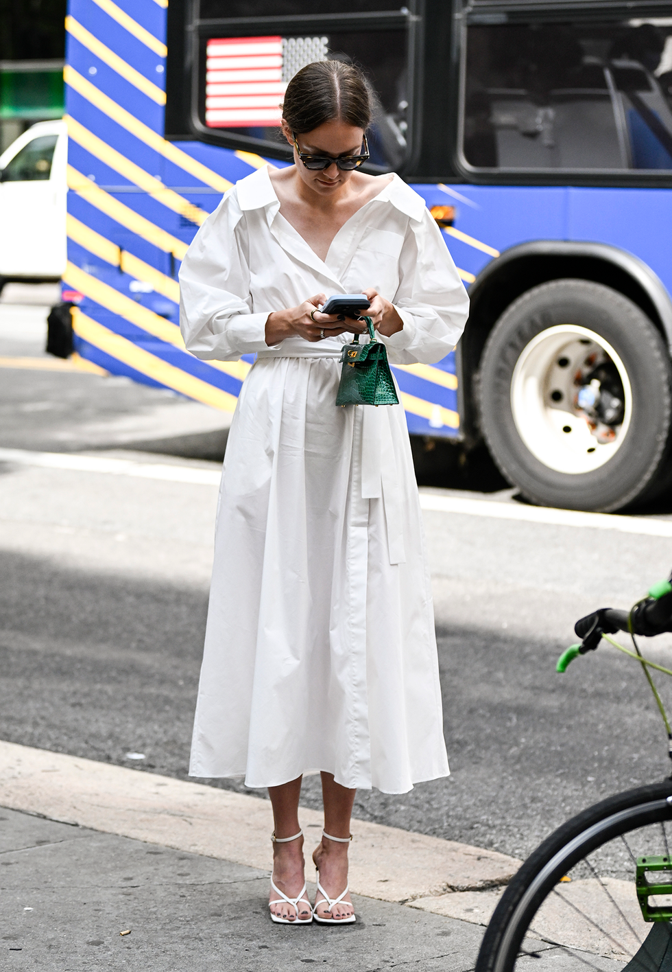 new york, new york september 11: a guest is seen wearing a white altuzarra dress and green mini bag outside the altuzarra show during nyfw s/s 2024 on september 11, 2023 in new york city. (photo by daniel zuchnik/getty images)