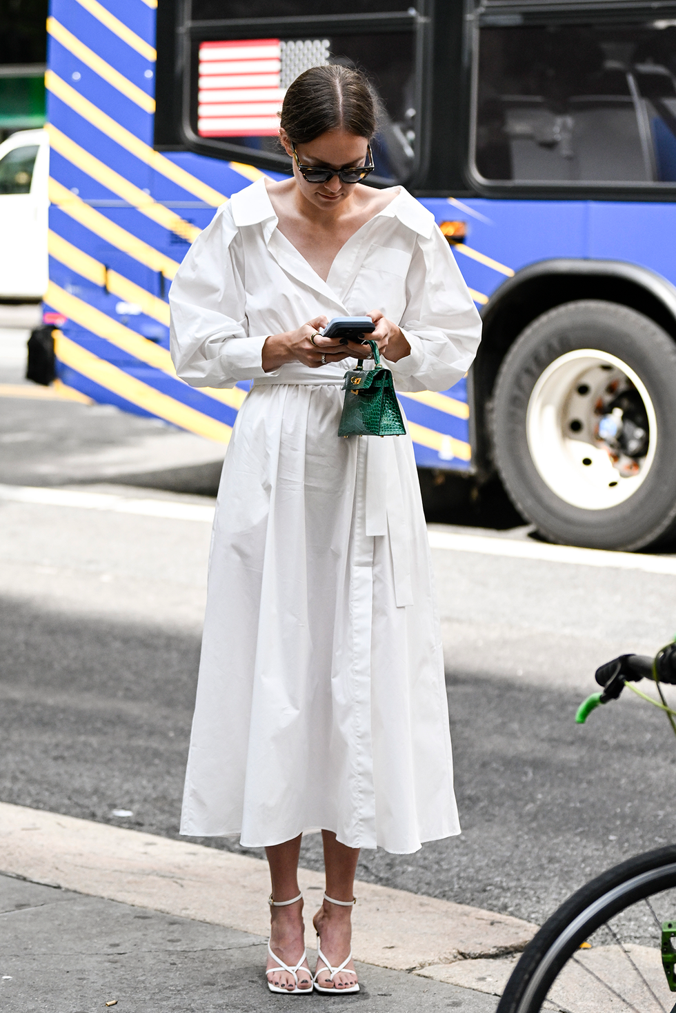 new york, new york september 11: a guest is seen wearing a white altuzarra dress and green mini bag outside the altuzarra show during nyfw s/s 2024 on september 11, 2023 in new york city. (photo by daniel zuchnik/getty images)