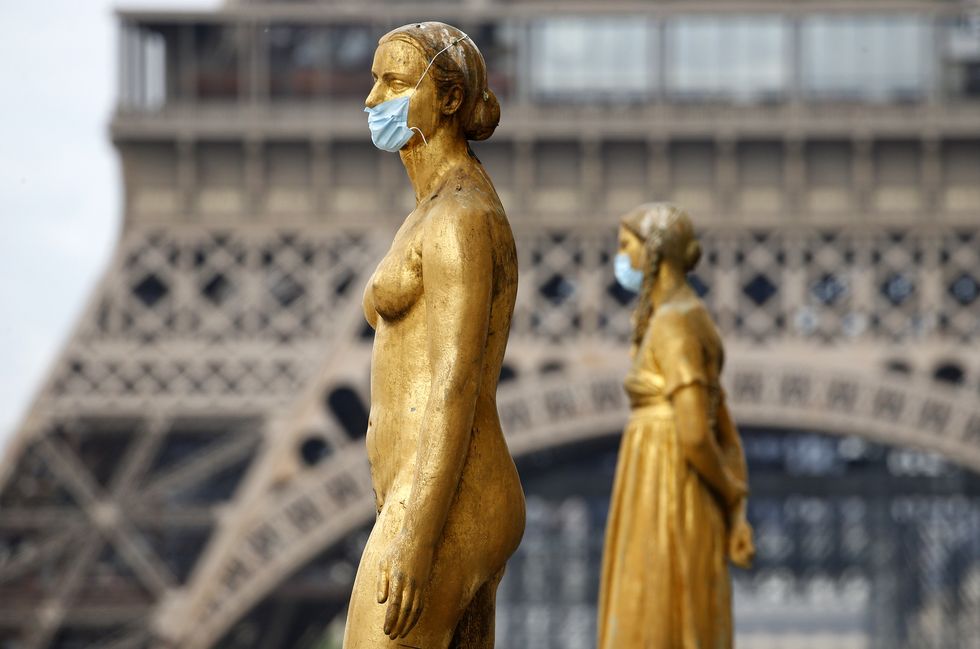 paris, france may 03 golden statues at the trocadero square near the eiffel tower wear protective face masks as the lockdown continues due to the coronavirus covid 19 pandemic, may 3, 2020 in paris, france the coronavirus covid 19 pandemic has spread to many countries across the world, claiming over 244,000 lives and infecting over 34 million people photo by chesnotgetty images