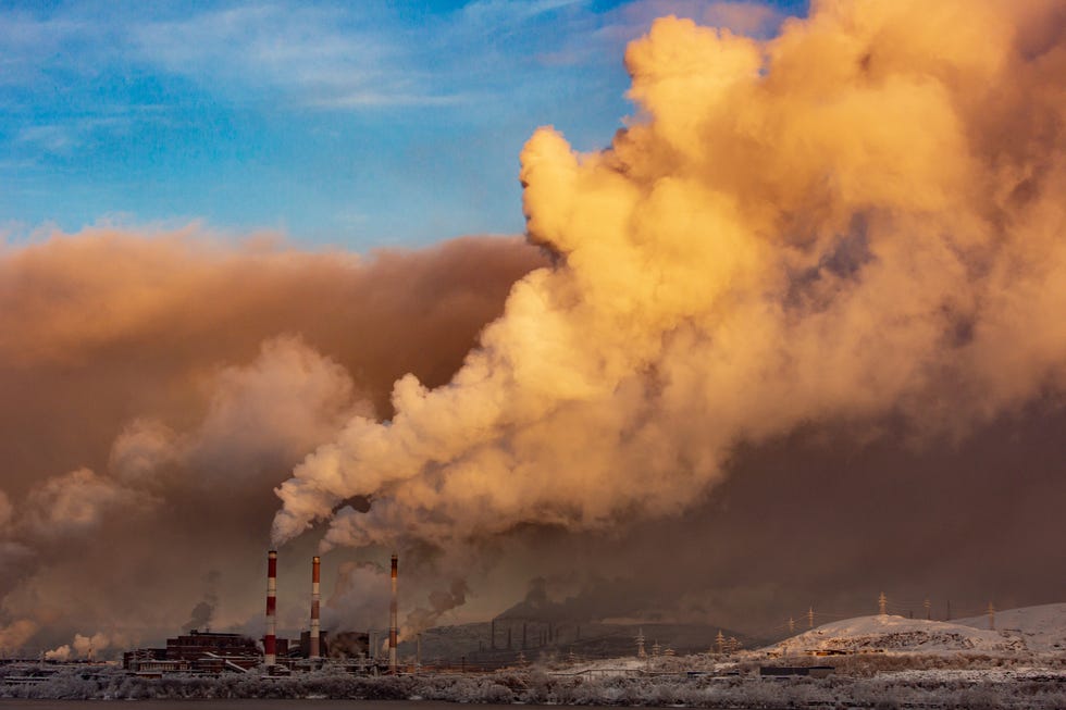 smoking chimneys on a background of blue sky, ecological disaster