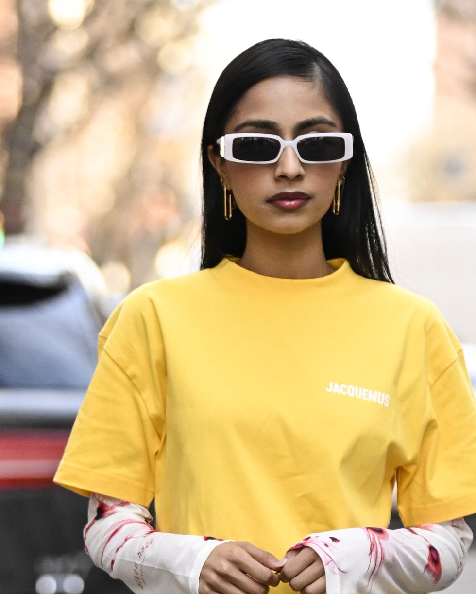 new york, new york february 13 malvika sheth is seen wearing a jacquemus yellow t shirt, miaou longsleeve top, issey miyake pleats please dress, tibi pants, saint laurent shoes and vintage louis vuitton bag outside the dennis basso show during new york fashion week fw 2023 on february 13, 2023 in new york city photo by daniel zuchnikgetty images