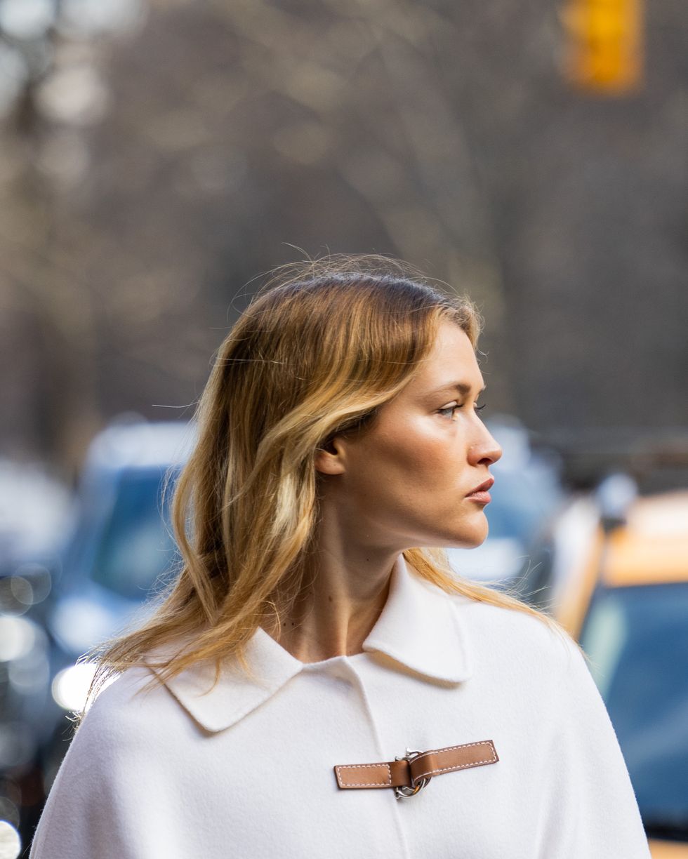 new york, new york february 13 chloe lecareux wears brown belt, white jacket with wide sleeves, brown bag, denim jeans outside carolina herrera during new york fashion week on february 13, 2023 in new york city photo by christian vieriggetty images