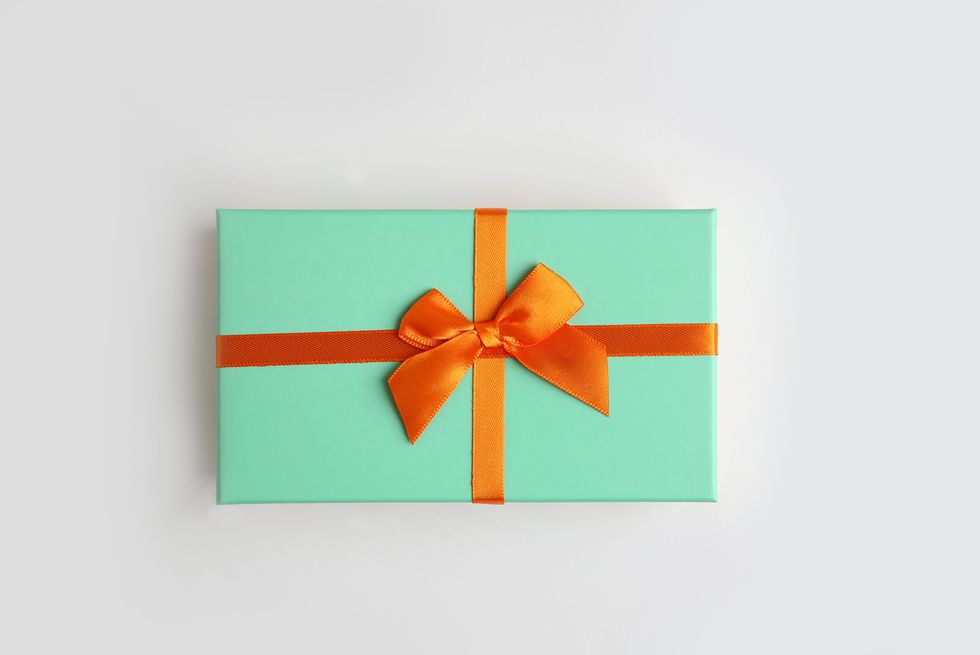 mint green color gift box with orange ribbon on white background isolate, copy space