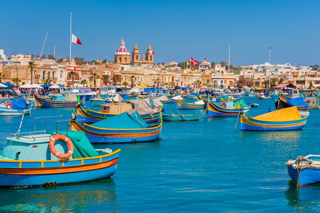 colourful boats in harbour of marsaxlokk, malta at springtime