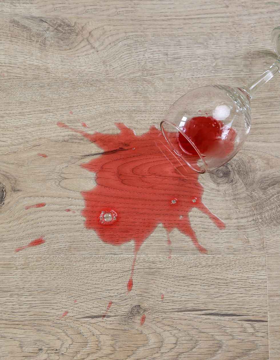 glass of red wine fell on laminate, wine spilled on floor flat lay top view