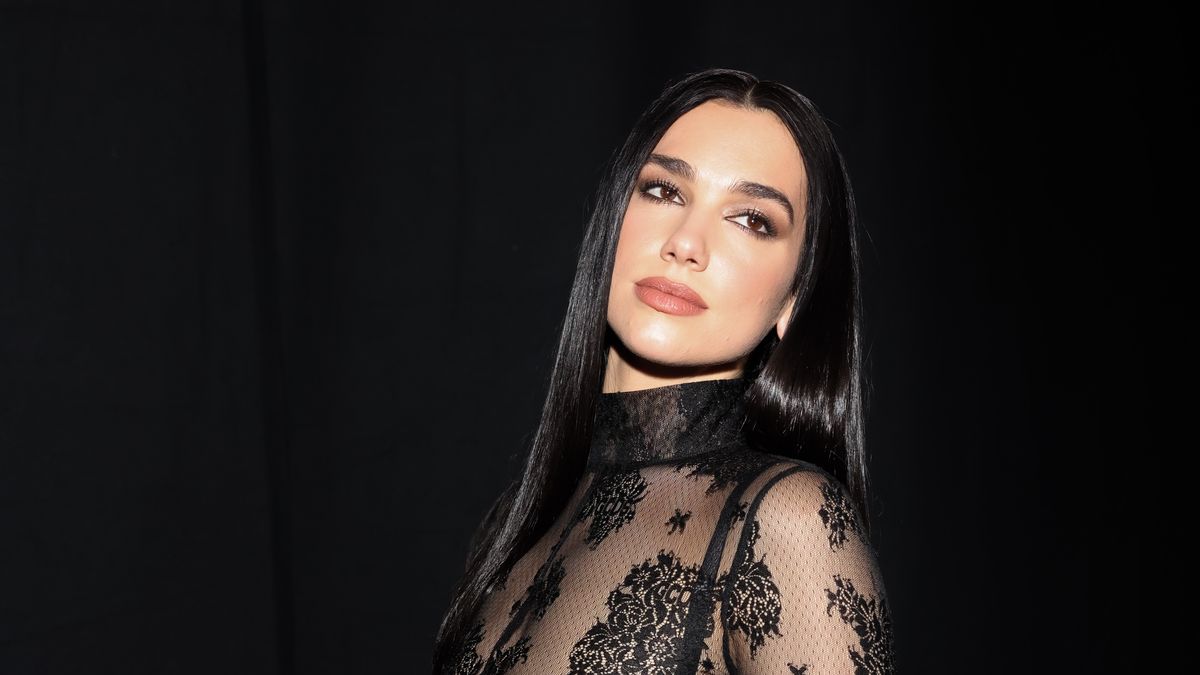 Dua Lipa Wears See-Through Lace Jumpsuit and Black Lingerie at GCDS Show