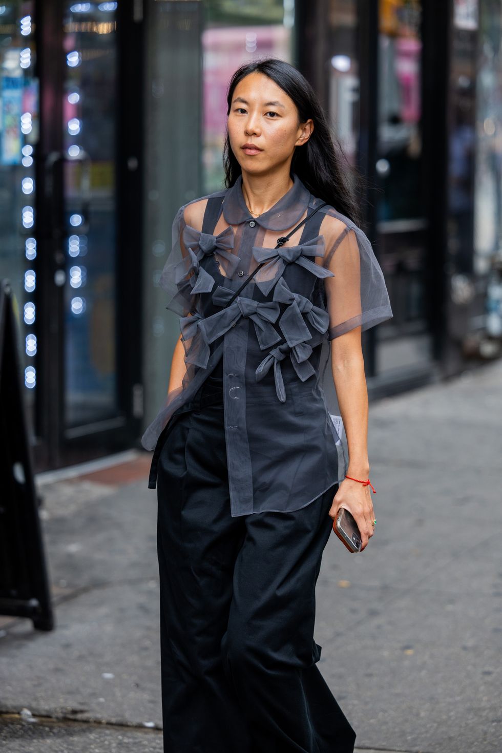 new york, new york september 13 a guest wears transparent grey top, black pants outside puppets and puppets on september 13, 2023 in new york city photo by christian vieriggetty images