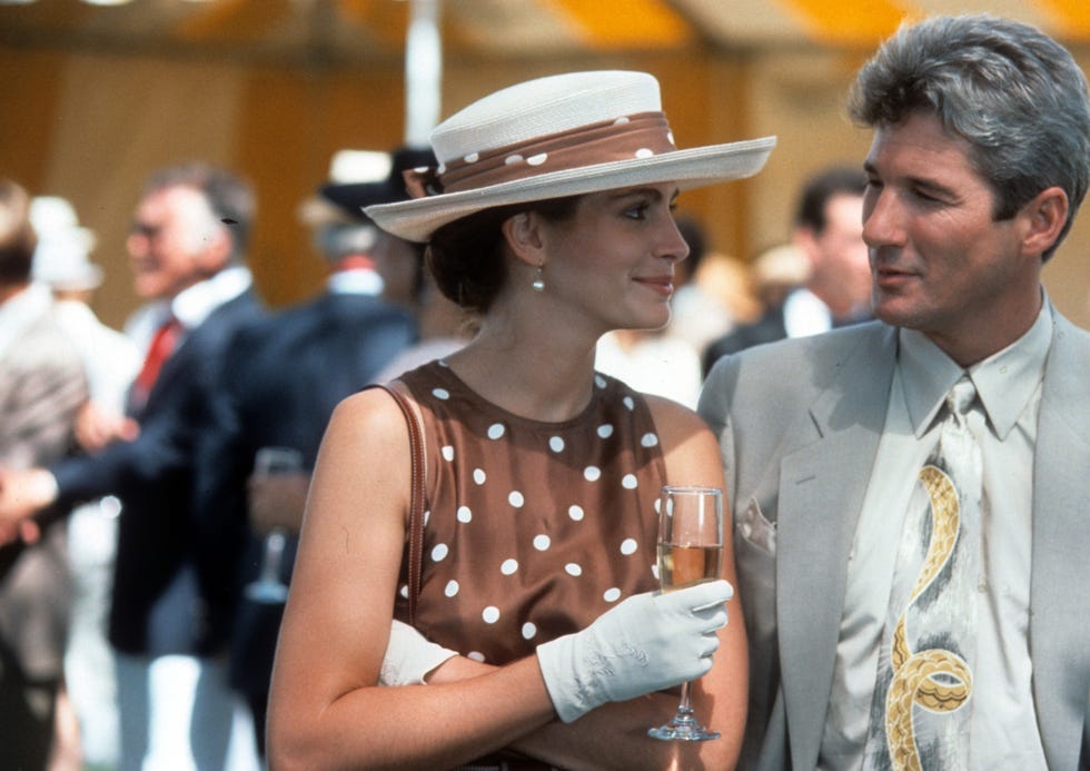 people at a social event one holding a champagne glass while wearing elegant attire