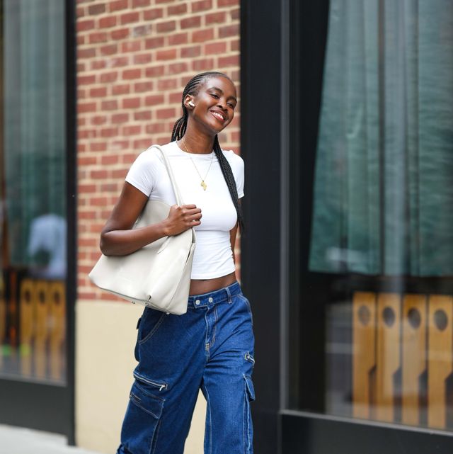 new york, new york september 09 a model wears a white cropped t shirt, blue cargo jeans pants, white sneakers shoes, a white bag, outside tibi , during new york fashion week, on september 09, 2023 in new york city photo by edward berthelotgetty images