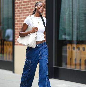 new york, new york september 09 a model wears a white cropped t shirt, blue cargo jeans pants, white sneakers shoes, a white bag, outside tibi , during new york fashion week, on september 09, 2023 in new york city photo by edward berthelotgetty images