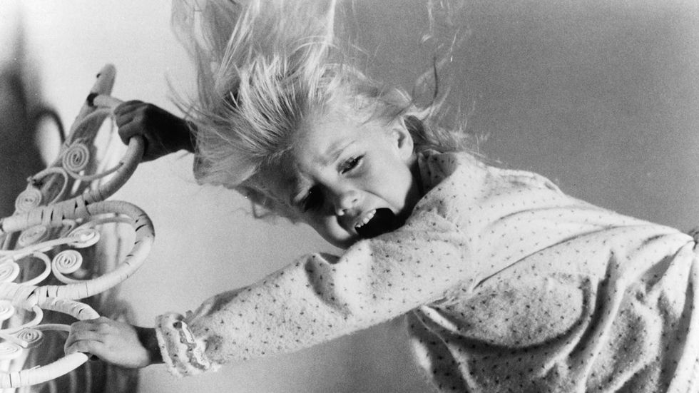 Heather O'Rourke screams as she is harassed by evil spirits in a scene from the film 'Poltergeist', 1982. (Photo by Metro-Goldwyn-Mayer/Getty Images)