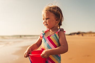 portrait of a young girl looking at the beach.