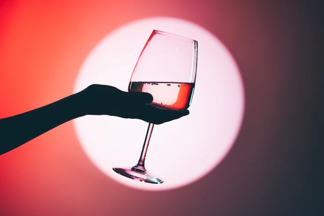 woman holding wine glass, close up