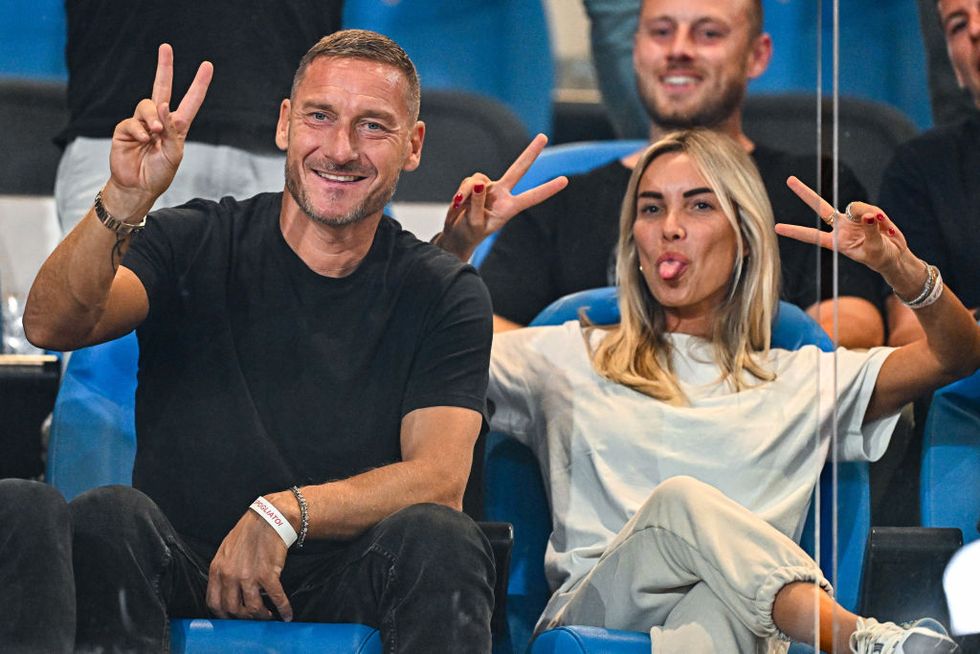 genoa, italy september 28 francesco totti, former captain of roma left, and his girlfriend noemi bocchi joke with photographers prior to kick off in the serie a tim match between genoa cfc and as roma at stadio luigi ferraris on september 28, 2023 in genoa, italy photo by simone arvedagetty images