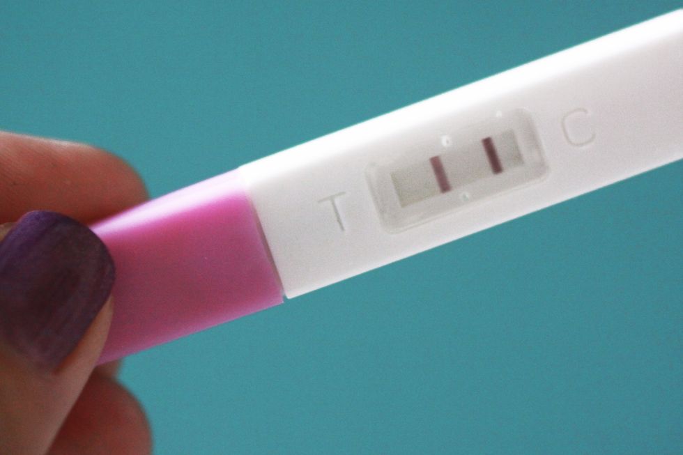 Pregnancy test, Fertility monitor, Skin, Nail, Finger, Pink, Health care, Hand, Material property, Service, 